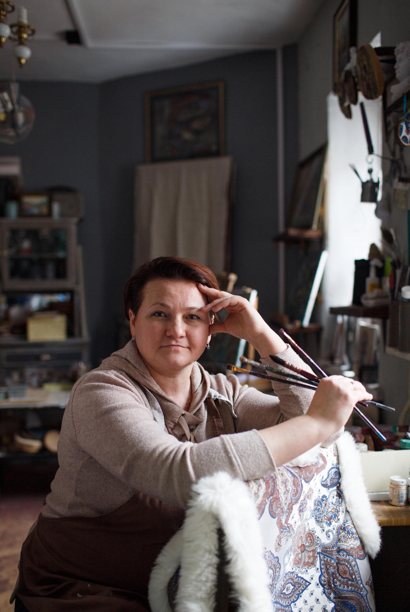 studio owner portrait standing by machine